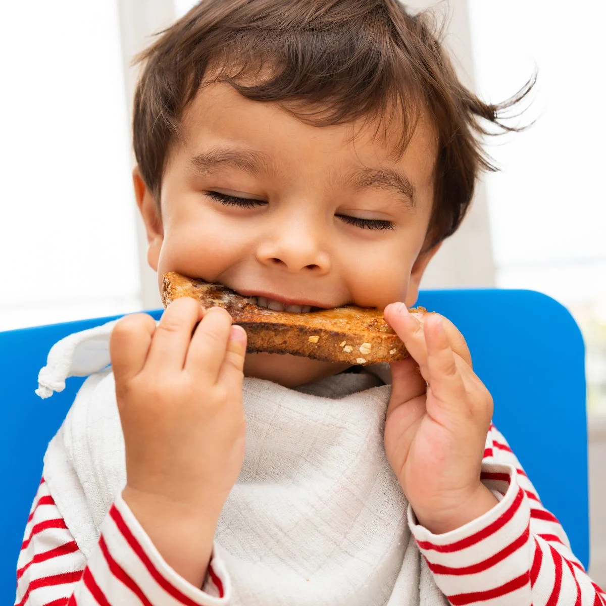 toddler eating sandwich