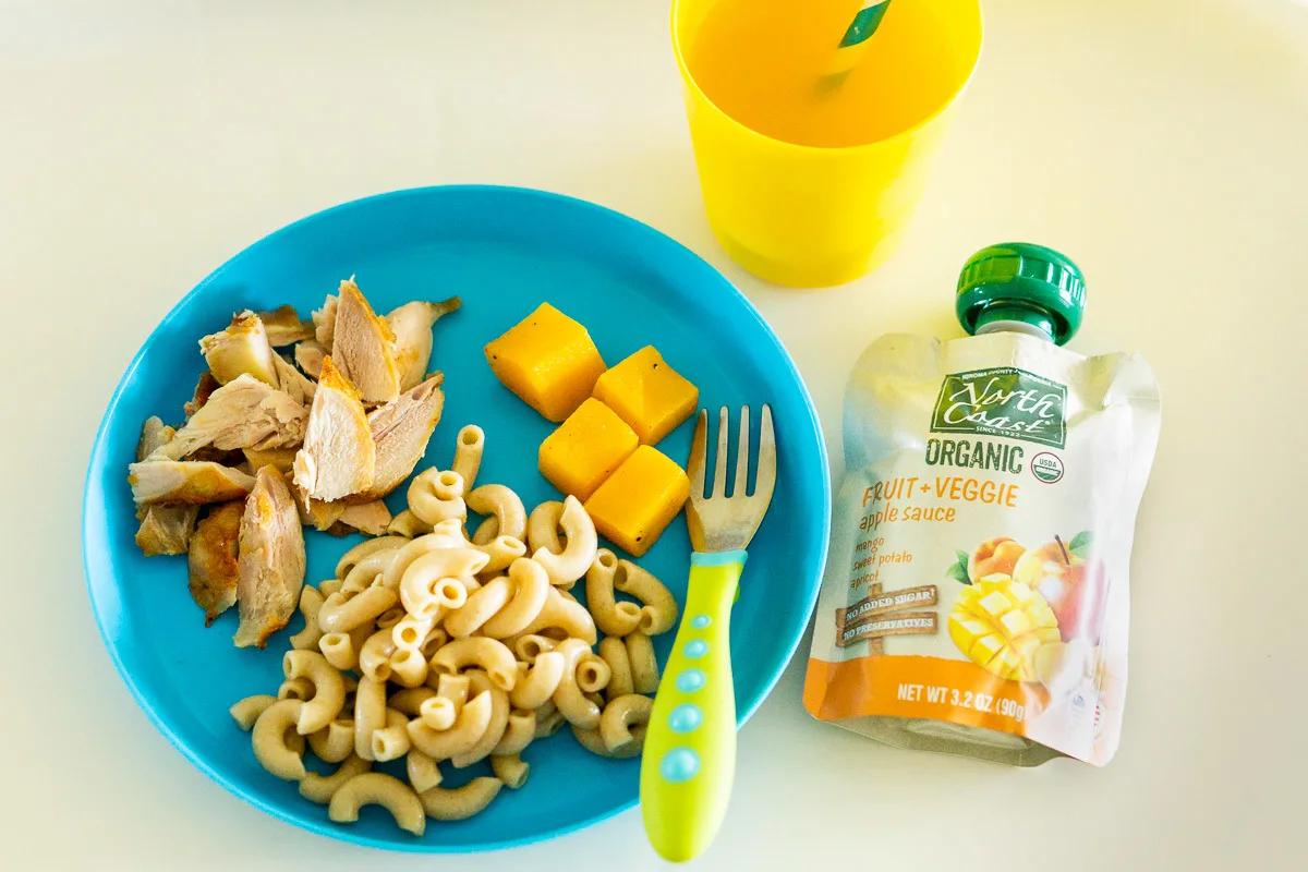 toddler dinner on a plate with a fruit pouch