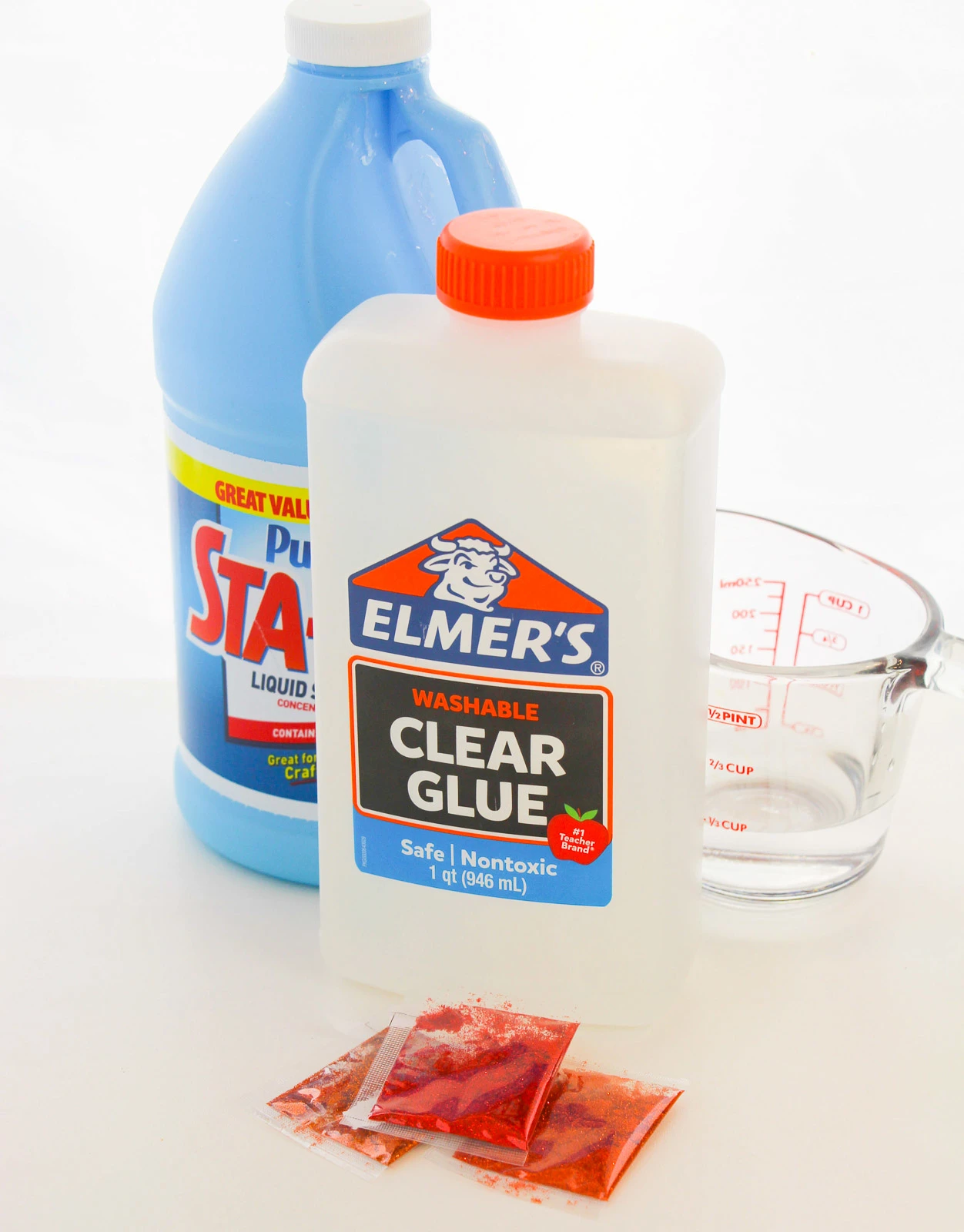 ingredients to make fall slime: glue, liquid starch, glitter, water