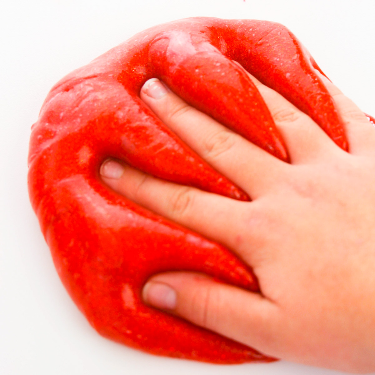 toddler hand squishing fall slime
