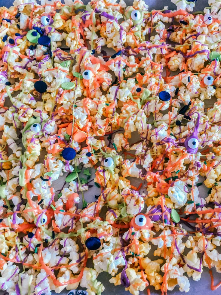 halloween popcorn with colorful halloween sprinkles on a baking sheet