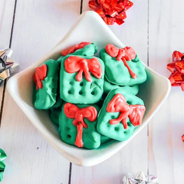 bowl of Christmas pretzel snacks surrounded by Christmas bows