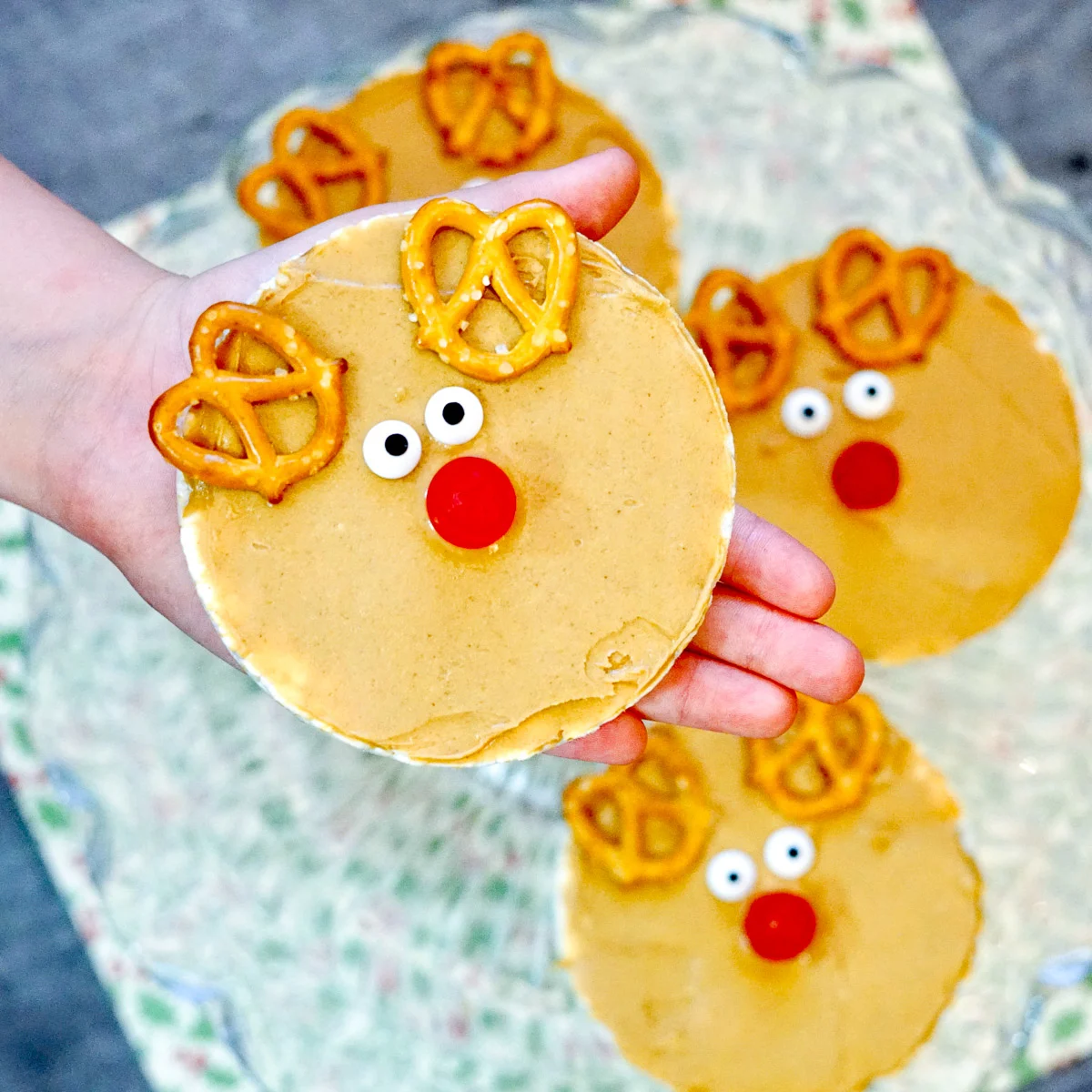child holding peanut butter rice cake rudolph snack