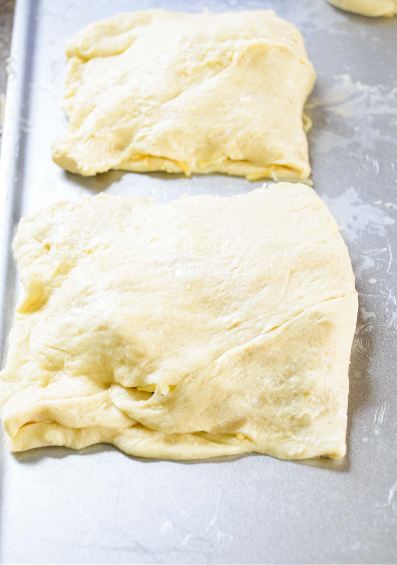 crescent roll breakfast pockets on a baking sheet