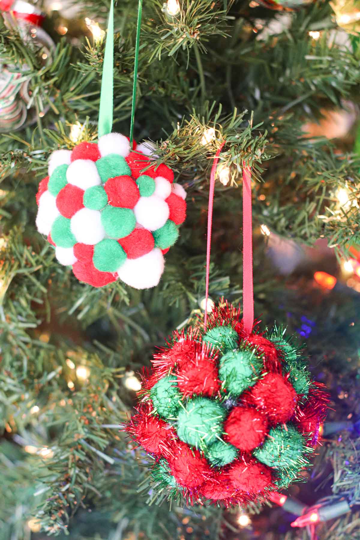 Pom pom Christmas ornament hanging on a tree.