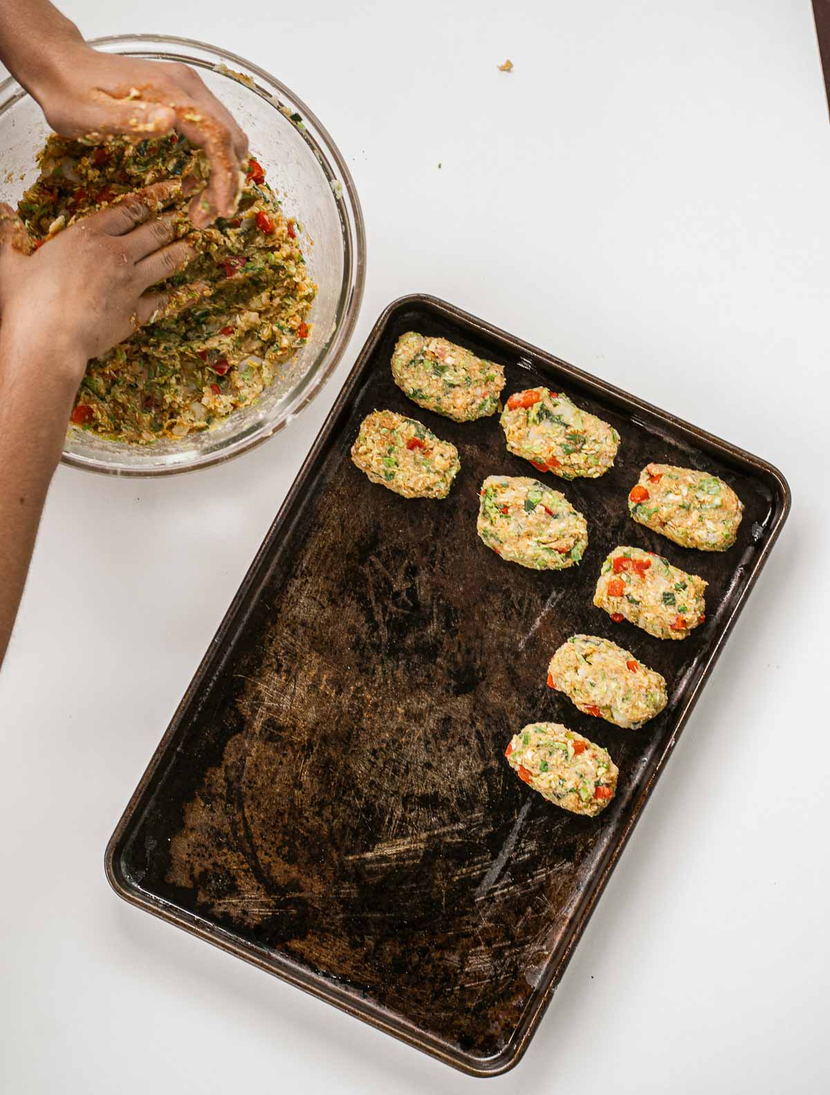 Forming veggie tots and placing them on a baking sheet