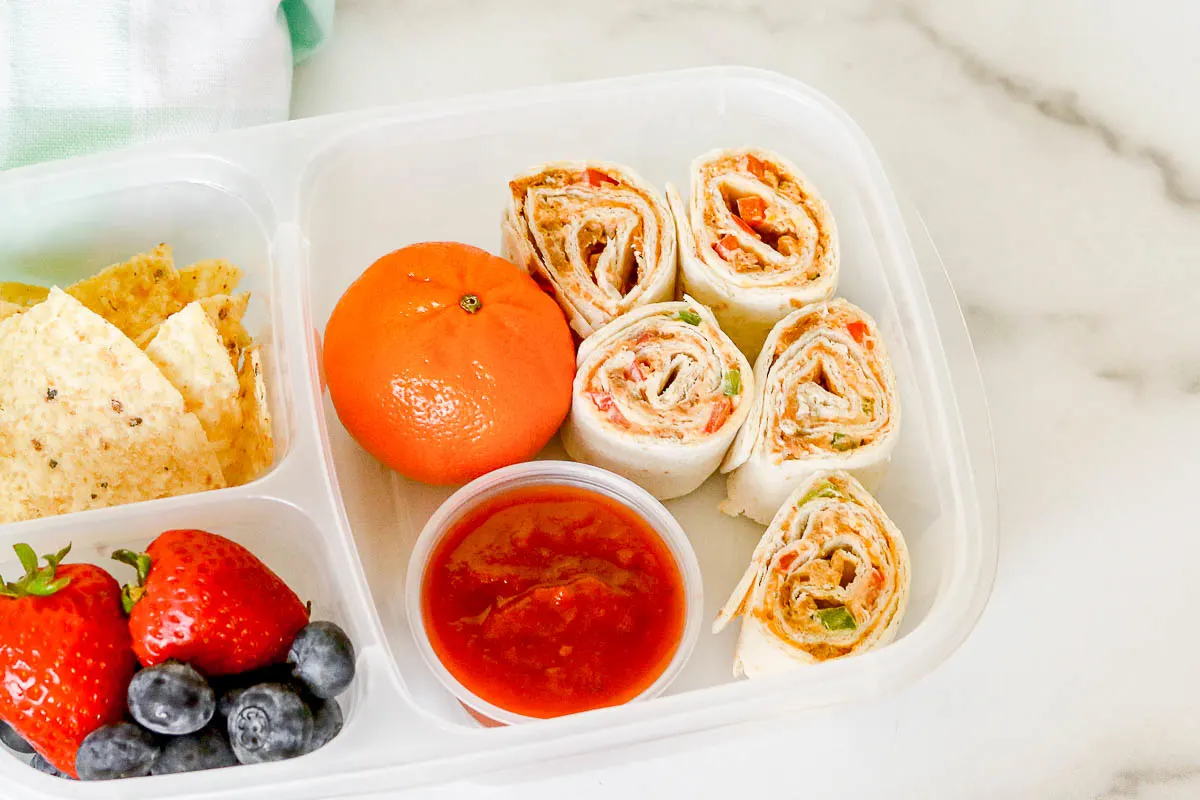 Packed school lunch with taco pinwheels.
