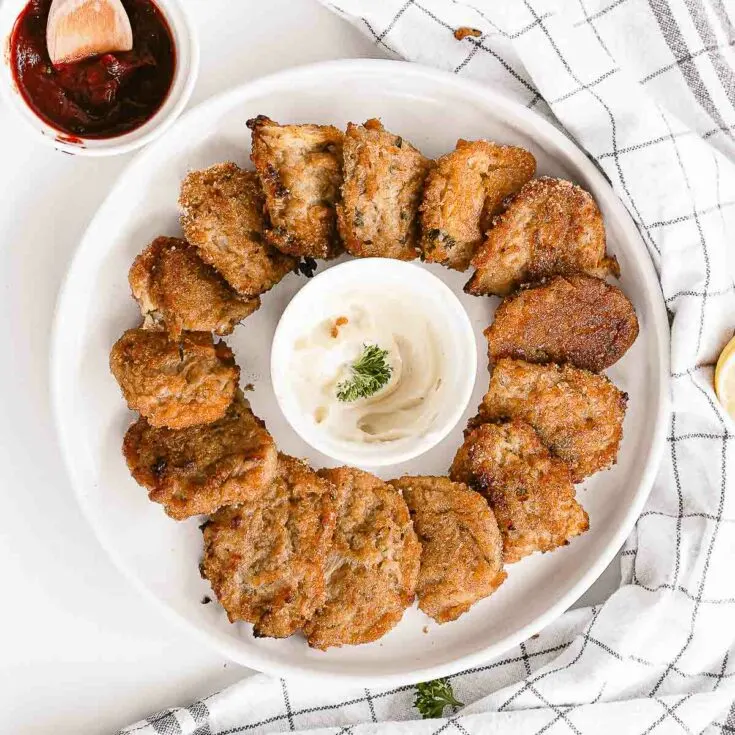 Cauliflower nuggets on a plate with dip.