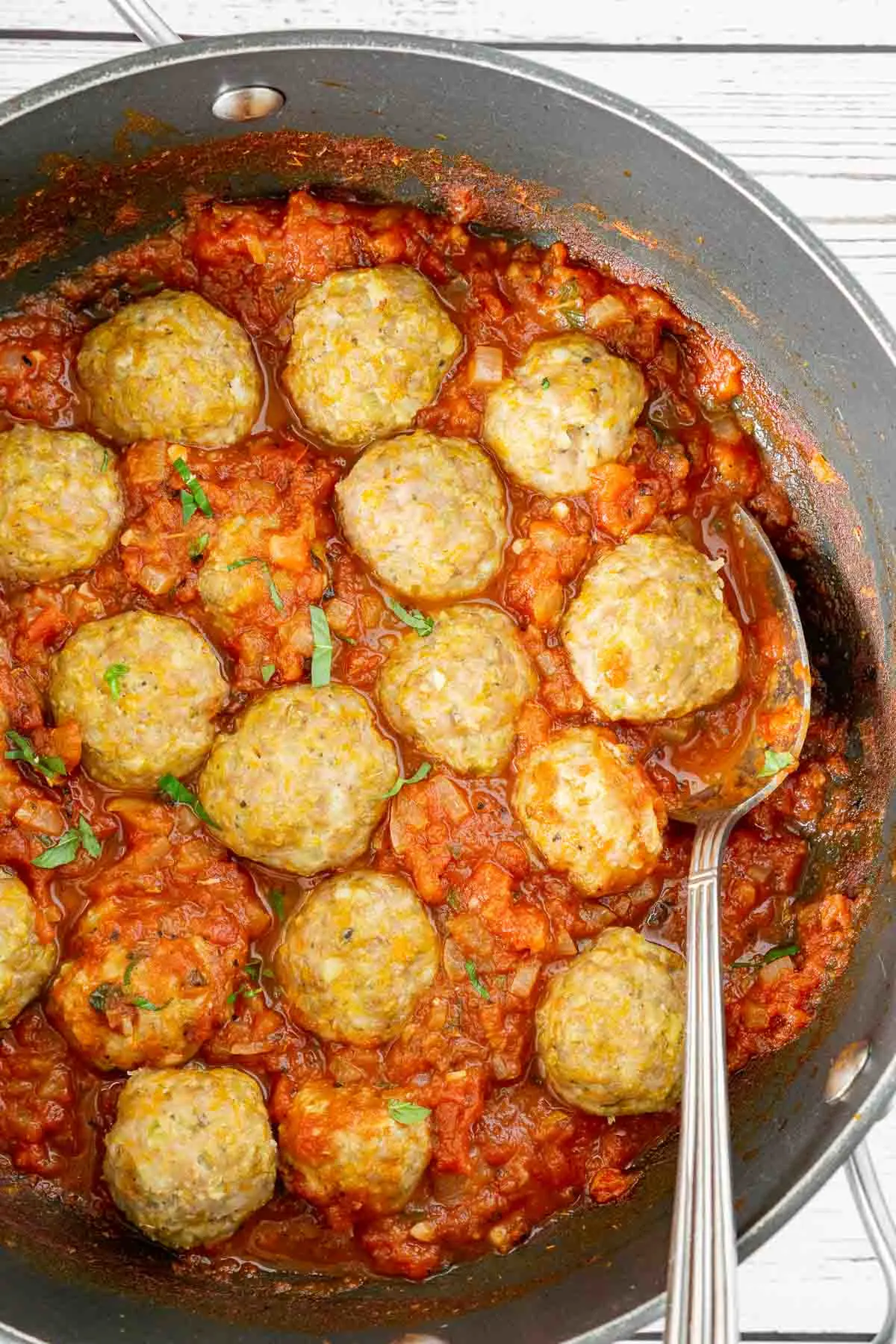 Pork meatballs in a casserole pan with tomato sauce